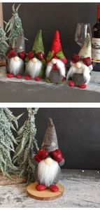Close-up of four festive Christmas gnomes with snowflake hats and red gloves over eyes