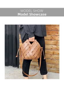 Detail of caramel leather woven handbag featuring V-shaped handle and drawstrings