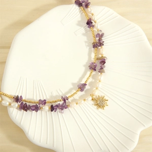 Detail of freshwater pearl necklace with purple gravel stones and sunburst pendant