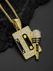 Close-up of gold hip hop cassette and microphone pendant with shiny rhinestones