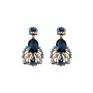Vintage baroque bronze earrings with blue stones and pearls on white background