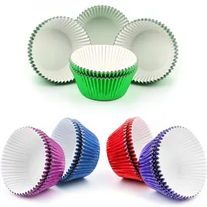 Colorful aluminum foil muffin liners in green, purple, blue, and red for baking cupcakes