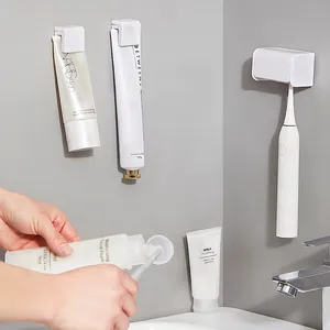 Wall-mounted white ABS toothbrush and toothpaste holder for bathroom organization