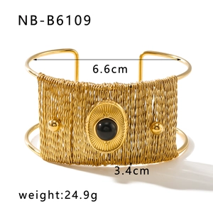 Detail view of ethnic wide gold-plated bangle with black stone and 3.4cm width