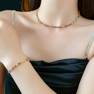Detailed view of colorful zircon tennis necklace and bracelet set in gold plating on model