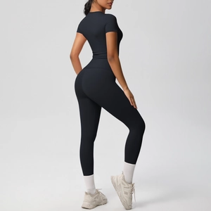 Detail view of black compression yoga set with high waist leggings and short sleeve top