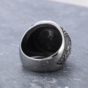 Close-up of vintage Viking wolf ring with Celtic knot patterns on silver stainless steel