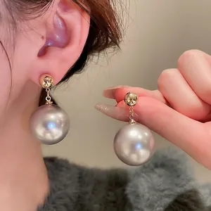 French vintage gold-plated drop earrings with large round grey pearls for a retro style