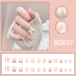 Sweet pink press-on nails with white heart, 3D bow, and silver glitter in a 24pcs set