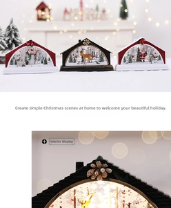 Detail of Christmas lantern with glowing snow scene featuring Santa and reindeer figures