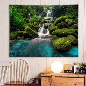 Detail of forest waterfall tapestry with lush green trees and mossy rocks on a bedroom wall