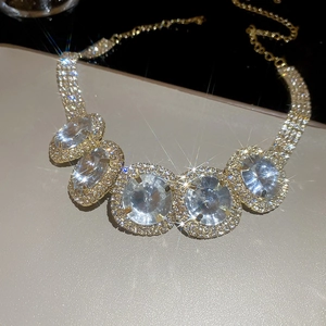 Detail of luxury gold choker with sparkling oval crystals and pavé rhinestones