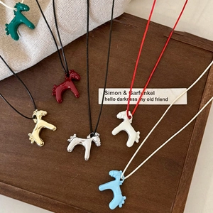Chic enamel pony pendant necklaces in vibrant colors on a minimalist display