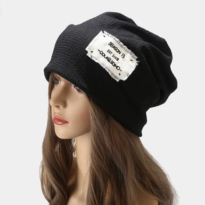 Fashionable black knit slouchy beanie with vintage white canvas label for men and women