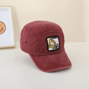 Detail view of burgundy washed cotton baseball cap with yellow excavator embroidery