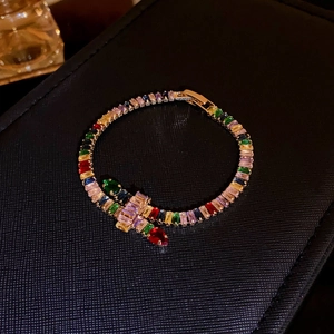 Detailed view of an elegant multi-color cubic zirconia bracelet on a black display box