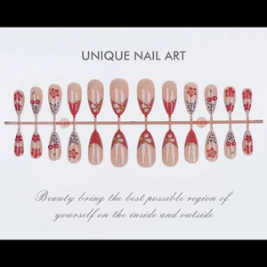 Detail showing long almond press-on nails with cherry, leopard, and floral patterns