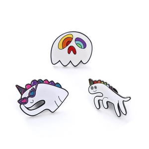 Three creative white unicorn enamel pins with colorful details on white background