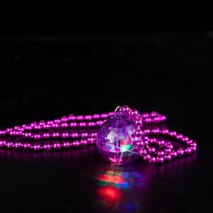 Close-up of a vibrant LED disco ball pendant glowing in purple with colorful lights