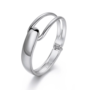 Detailed view of the silver multi-layer metal bangle with hinge and buckle closure