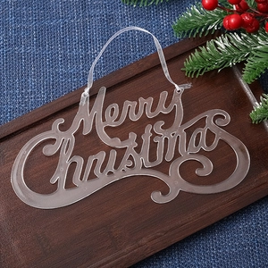 Close-up of Merry Christmas script acrylic pendant on a rustic wooden tray with pine needles