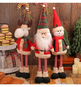 Close-up of telescopic Christmas figures including Santa, Snowman and Reindeer on wood