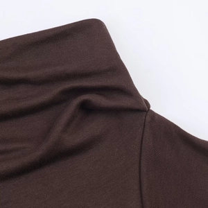 Detailed macro view showing the brown knitted texture and soft turtleneck collar design