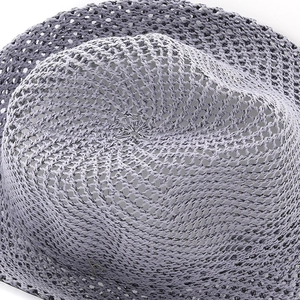 Macro detail of breathable grey woven straw texture on a summer jazz sun hat