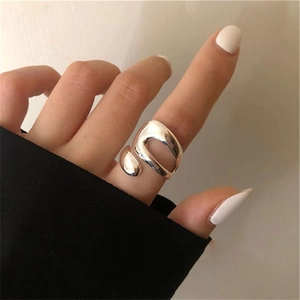 Macro detail of silver S925 sterling silver water drop ring with fluid organic design