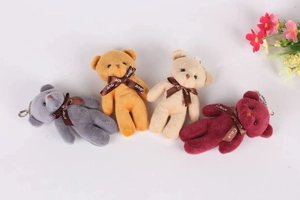 Detail showing four plush bear pendants in grey, gold, white and burgundy colors