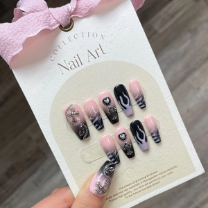 Pink and black gradient press-on nails with 3D metal hearts and punk flame patterns