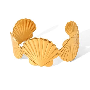 Detailed view of the gold-plated scallop shell patterns on an open cuff ocean bracelet