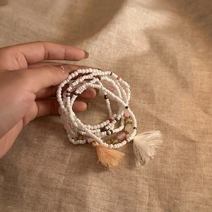 Close-up of bohemian multi-layer beaded bracelet set with star charms and tassels