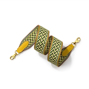 Wide woven shoulder strap with yellow wave pattern and gold hooks for crossbody bags