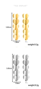 Tile display showing gold and silver tiered heart earrings with measurements and weight