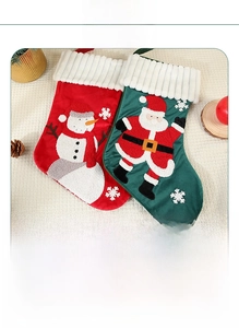 Detailed view of large embroidered Christmas stockings with plush faux fur cuff trim