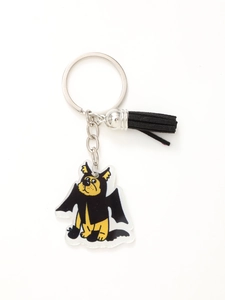 Detail of Halloween keychain with black tassel and cute acrylic dog charm on white background