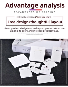 Close-up of minimalist white and black jewelry display cards with hanging hole design