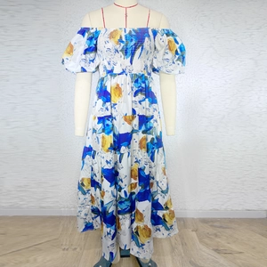 Detail of floral off-shoulder summer dress with ruched elastic bust and puff sleeves