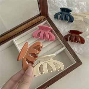 Set of five colorful resin hair claws in pink, orange, beige, blue and brown
