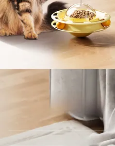 Detail view of yellow tumbler cat toy showing the food dispenser and rolling ball