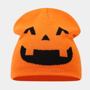 Close-up of orange knitted beanie featuring a black woven Jack-o'-lantern pumpkin face