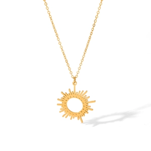 Close-up of golden sunflower pendant necklace with eight-pointed star detail on white surface