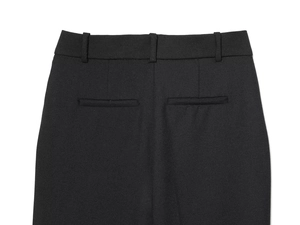 Close-up detail of black trousers showing the back pocket and twill fabric texture