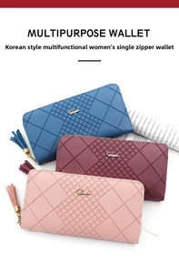 Three long zipper wallets in blue, red, and pink with geometric embossed texture and tassels
