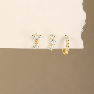 Detailed view of three-piece gold S925 silver earring set with clover and star motifs