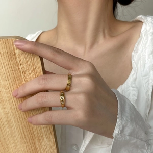 Close-up of gold star and moon embossed ring set with micro zircon inlay on model's hand