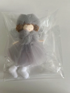 Detail of grey plush Christmas angel ornament in packaging with mesh skirt and fur hat