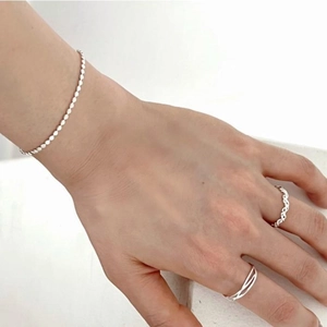 Minimalist S925 sterling silver bead bracelet and geometric intertwined rings on hand