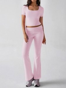 Detail view of pink Y2K two-piece set featuring square neck crop top and flared high waist pants